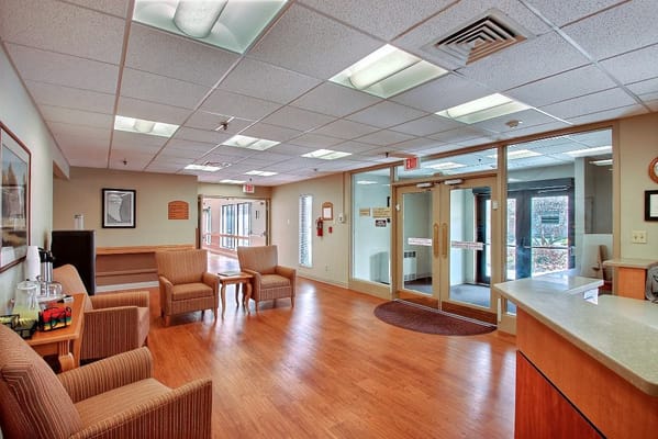Interior view of a lobby with chairs and reception area