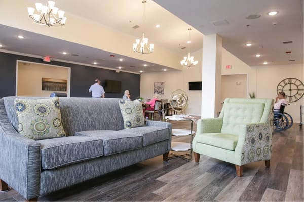 Cozy living room seating area with decorative chairs and a couch