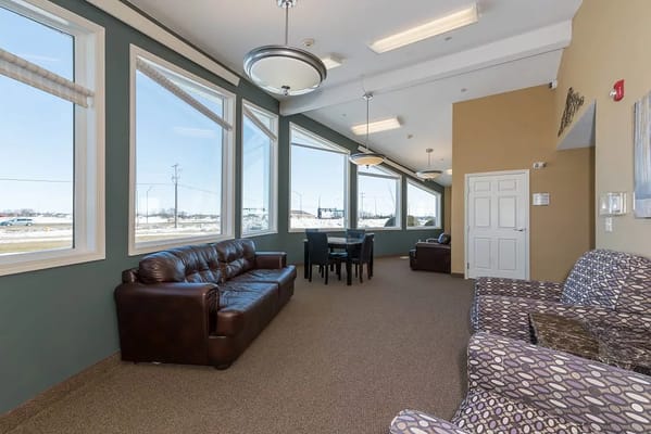 Bright common area with seating and large windows