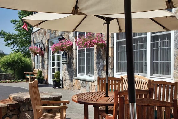 Outdoor seating area with tables and umbrellas
