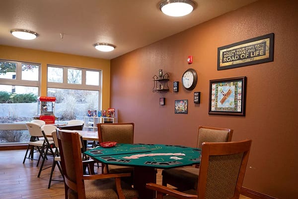 Interior view of the game room featuring a green table and board games.