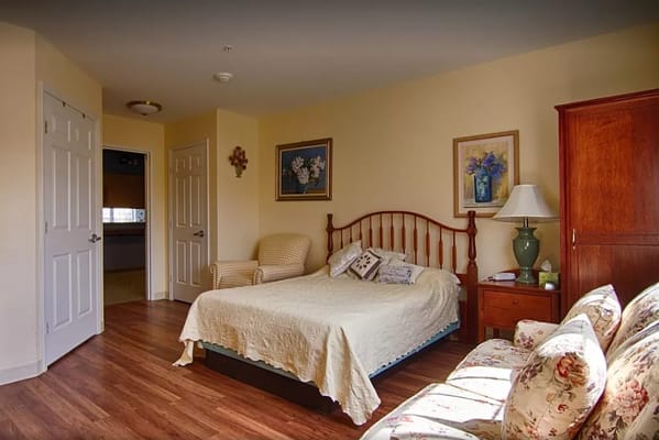 Cozy bedroom with a bed, chair, and dresser