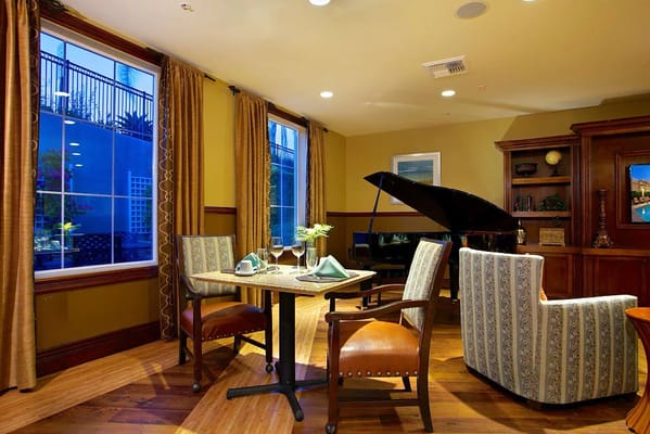 Cozy common area with piano and dining setup