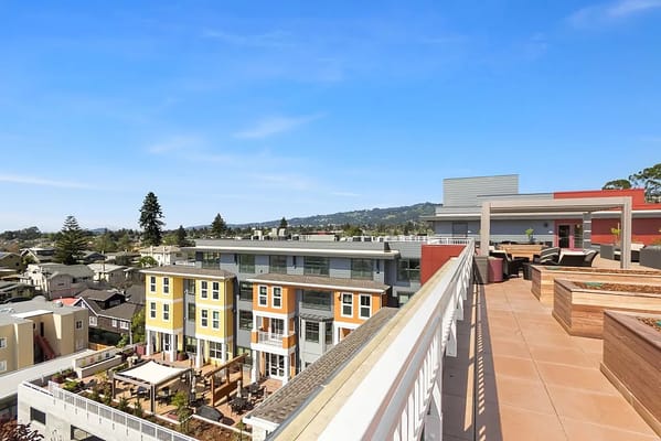 View from the rooftop terrace overlooking residential area and hills