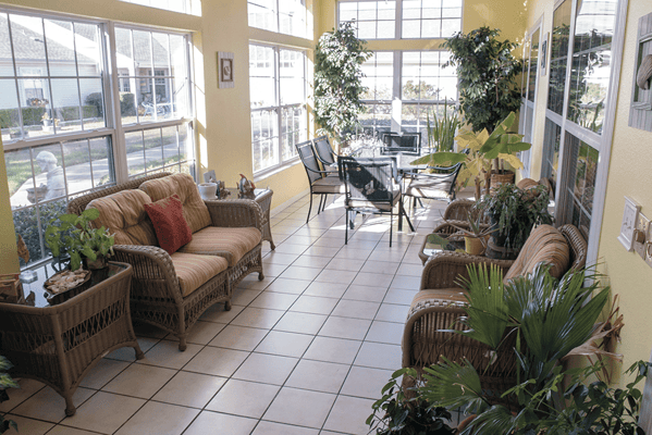 Bright sunroom with seating and plants