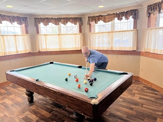 Resident playing billiards at Montello Heights