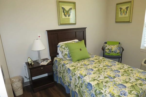 Cozy resident room with floral decor and a bed