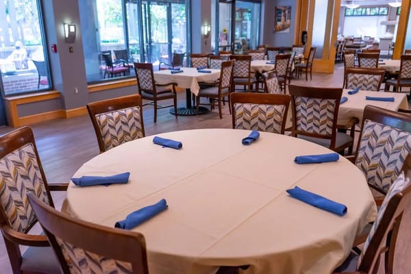 Dining area setup with blue napkins on tables