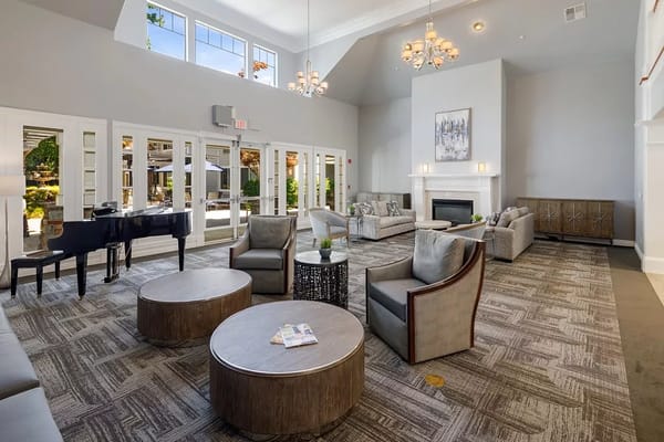 Interior of a common area with seating and a piano