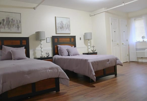 Brightly lit shared bedroom in assisted living facility