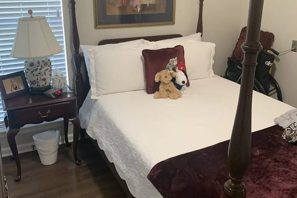 A well-furnished bedroom at Oakwood Village with a queen-sized bed and decorative accessories.