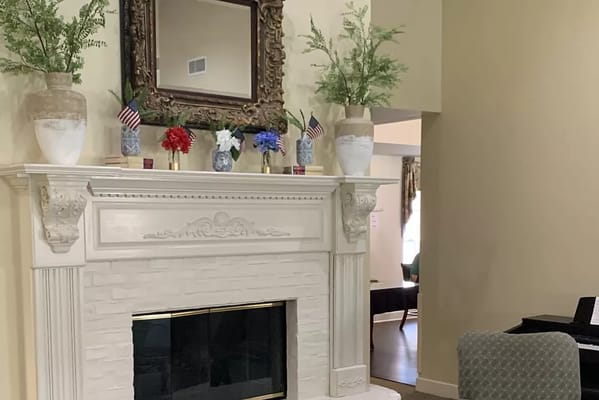Decorative fireplace with flowers and a mirror
