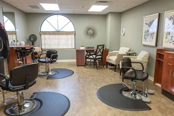 Interior view of the salon featuring styling chairs and wash station.