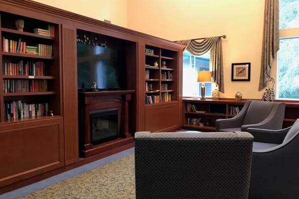 Library lounge with bookshelves and comfortable seating
