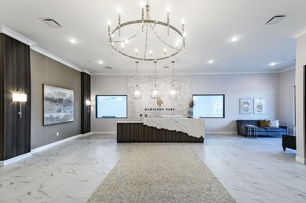 Modern lobby area with chandelier and reception desk