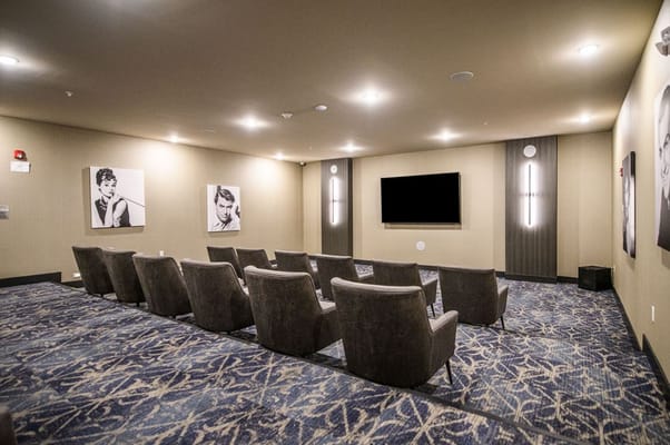 A cozy interior movie room with comfortable seating