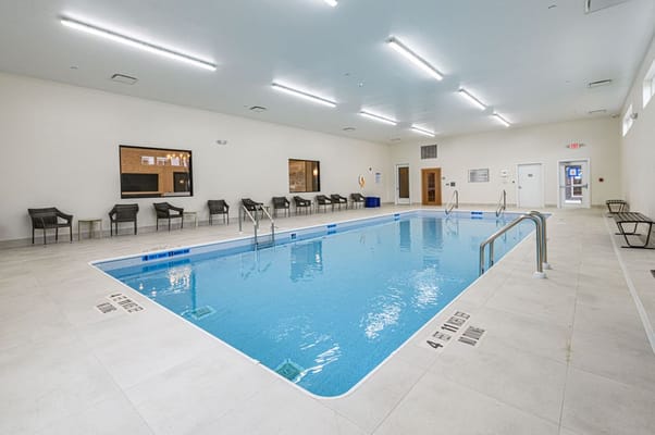 Indoor swimming pool area with seating