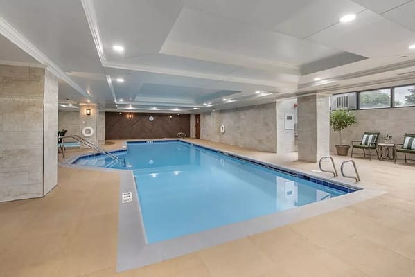 Indoor swimming pool area with lounge chairs