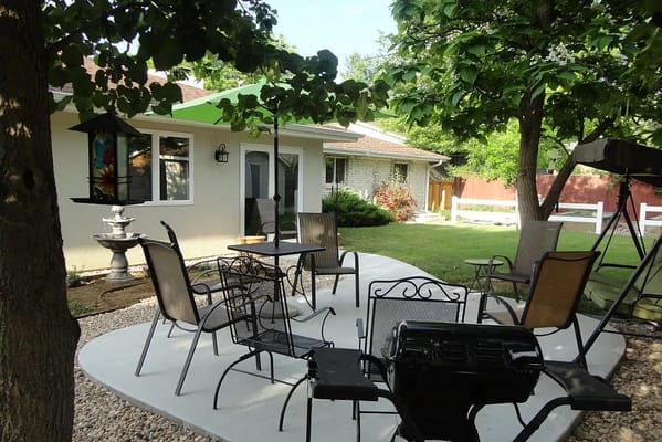 Outdoor seating area with trees and garden features
