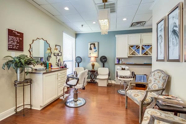 Interior of the salon with styling stations and decorative elements.