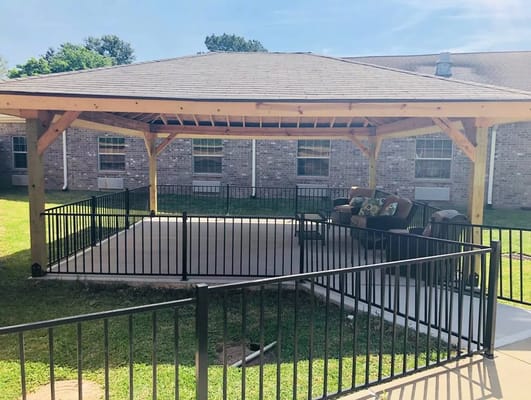 Covered outdoor patio with seating at Capstone Healthcare Estates