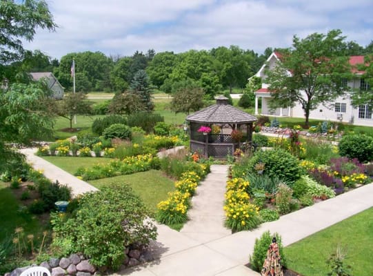 Beautiful landscaped garden with a gazebo at Pine Brook Pointe