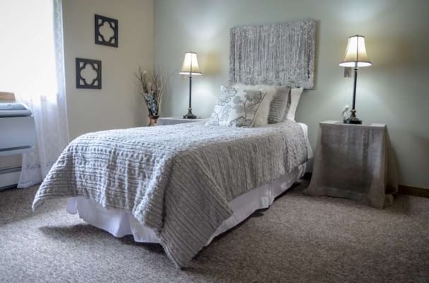 Cozy resident room with a bed and lamps