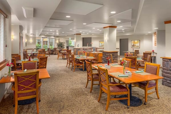 Bright dining room with tables and flowers