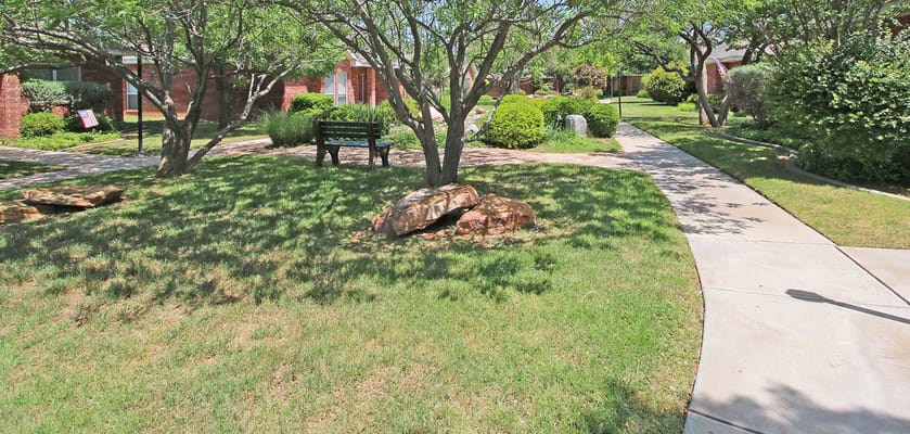 Lush garden path with benches and greenery at Vogel Center.