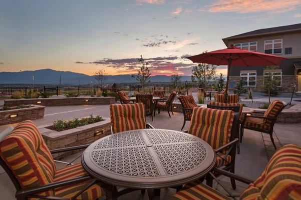 Outdoor seating area with mountain view at sunset