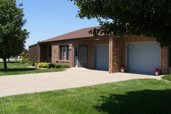 Main entrance view of Risen Son Christian Village with greenery and flowers