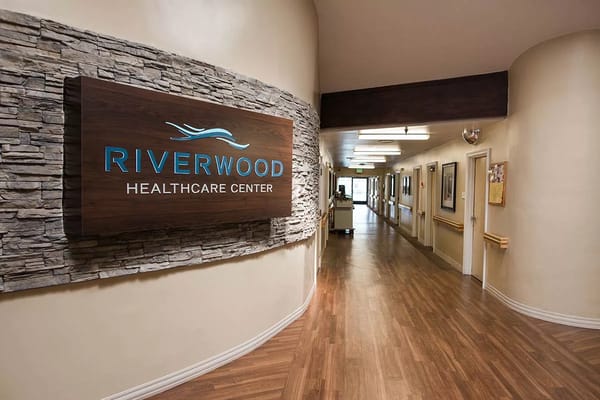 Interior hallway of Riverwood Health Care Center featuring the reception area.