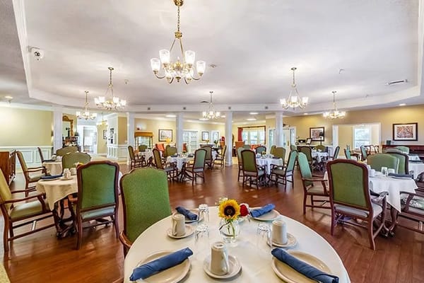 Dining area set up for a meal service with tables and chairs
