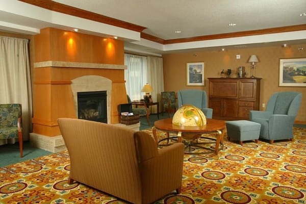 Comfortable lounge area with seating, fireplace, and decorative globe.