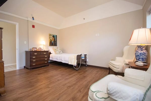Bright interior of a private resident room with furniture