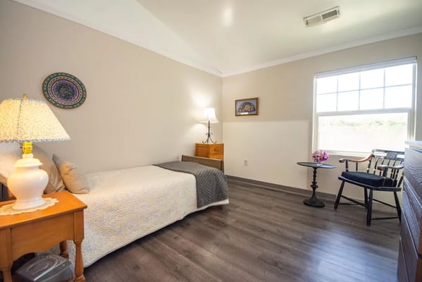 Private resident room with bed and furniture