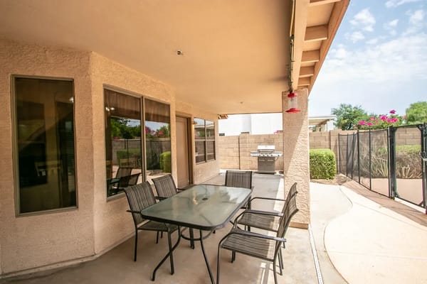 Outdoor patio area with seating and grill