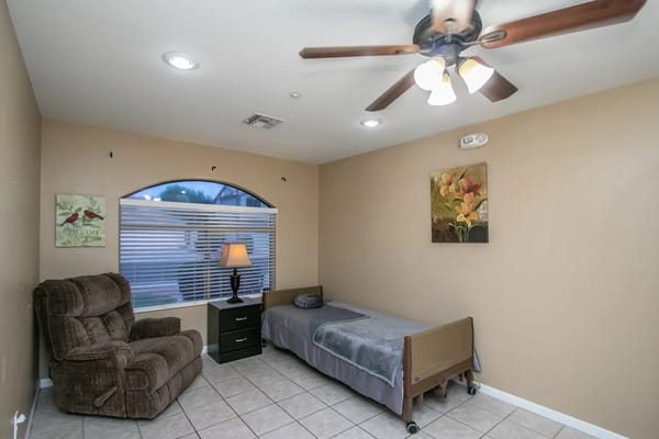 Cozy resident bedroom with chair and lamp