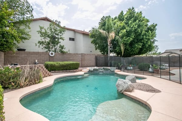 Swimming pool area surrounded by greenery