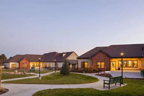 Exterior of Beatrice Hover Assisted Living Residence with landscaped pathways and lighting