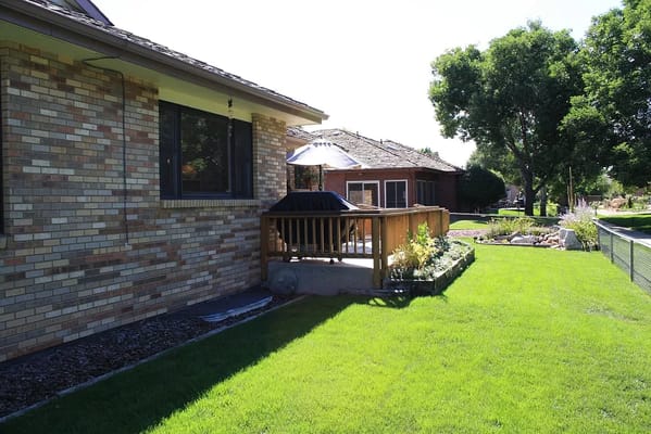 Outdoor space with well-maintained lawn and patio