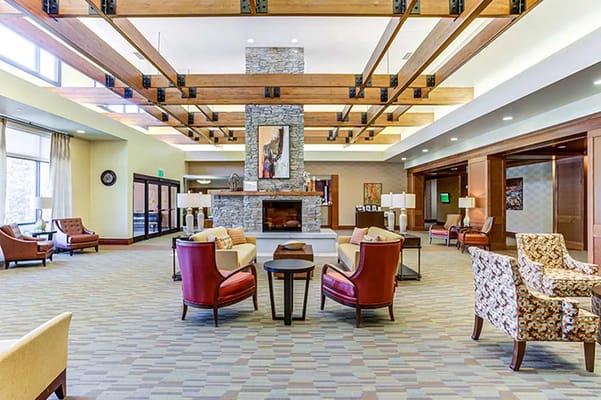 Spacious lounge with comfortable seating and a stone fireplace