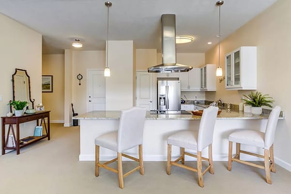 Modern kitchen with island seating and silver appliances