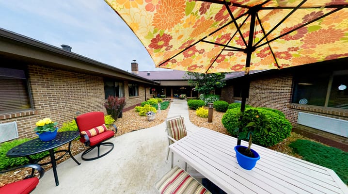 Outdoor seating area with umbrella and plants