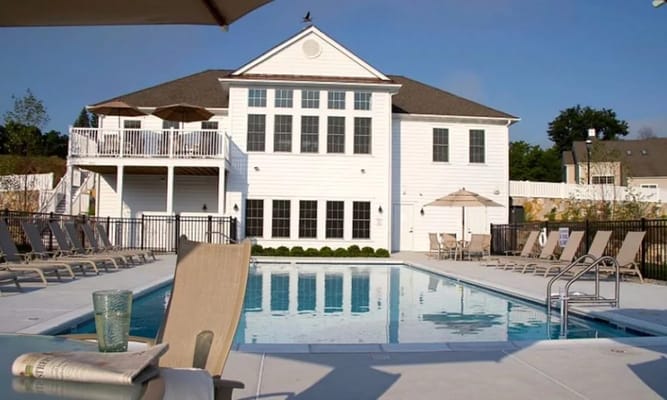 Outdoor pool area with building in the background