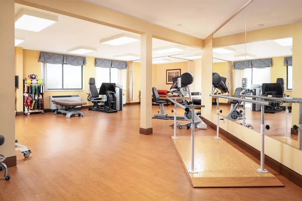 Bright and spacious therapy room with exercise equipment