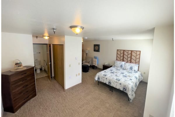 A private resident room with a bed and furniture