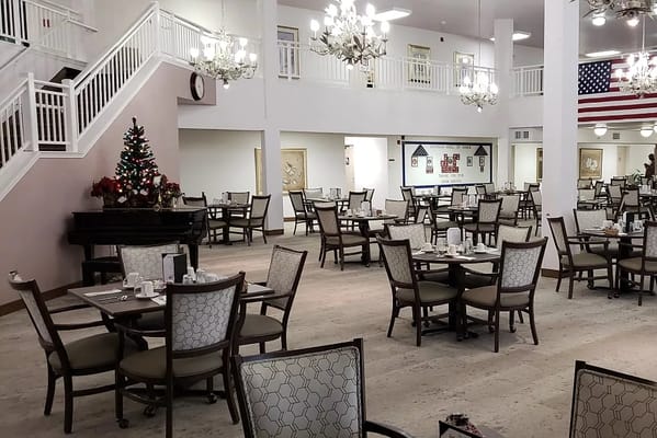 Cozy dining area with festive decorations and tables set for meals