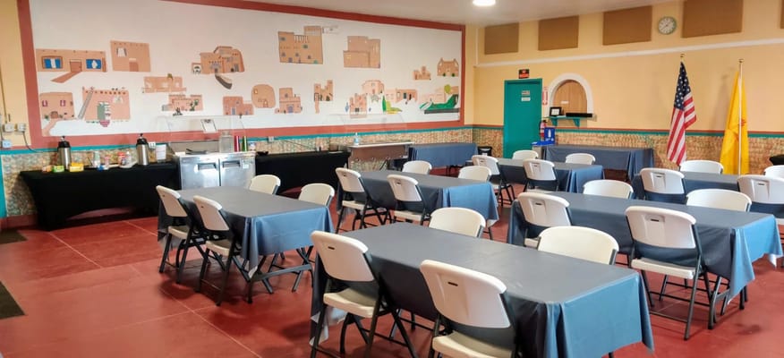 Dining area with tables and chairs set up for an event