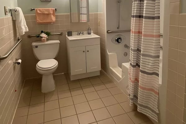 Clean and accessible bathroom with shower and toilet facilities